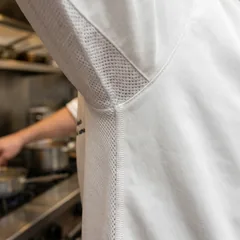 Polyester mesh panel sewn into a chef coat side seam