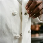 Knot buttons and snaps on chef coat fronts