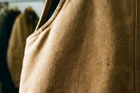 Cotton duck shell fabric for insulated coveralls