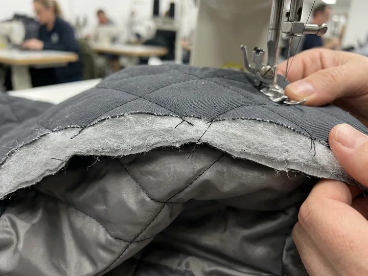 Polyester fill quilted to a taffeta lining, cut edge
