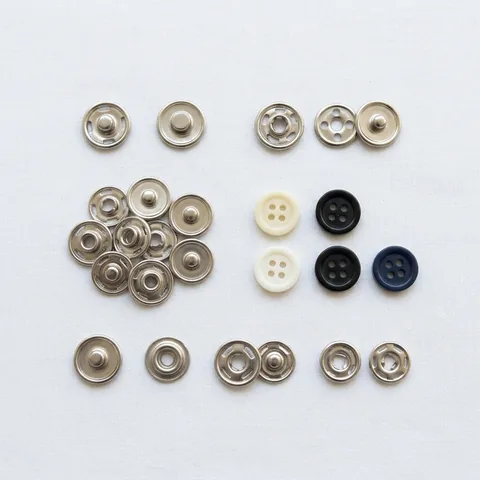 Metal snaps and buttons for FR shirts