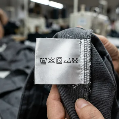 Close-up of a printed care label with care symbols